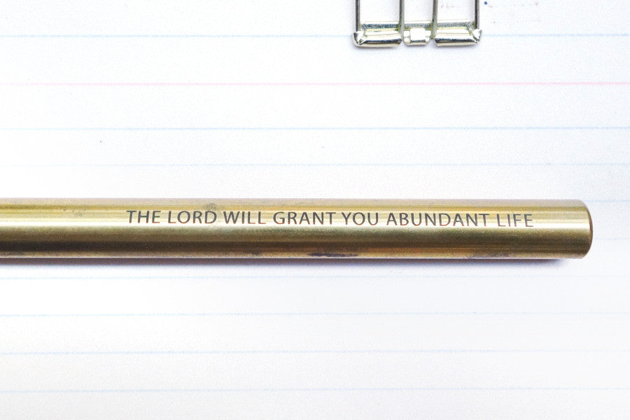 Brass pen barrel with the message 'The Lord will grant you abundant life'.