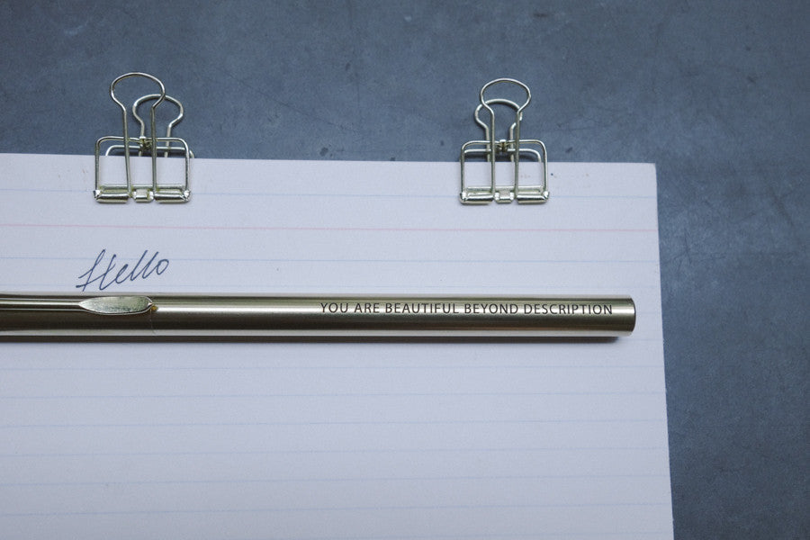 Brass pen barrel with the message 'You are beautiful beyond description'.