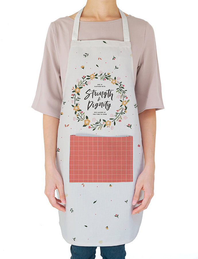 White apron with floral details. 'She is clothed with strength and dignity'. Gift it to your favourite home chef!