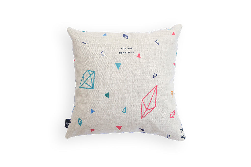 The back of the linen cushion is diamond details with dark blue fonts 'you are beautiful'.