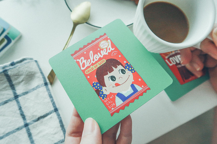 Beloved Child of God wooden Christian coaster beside a drink