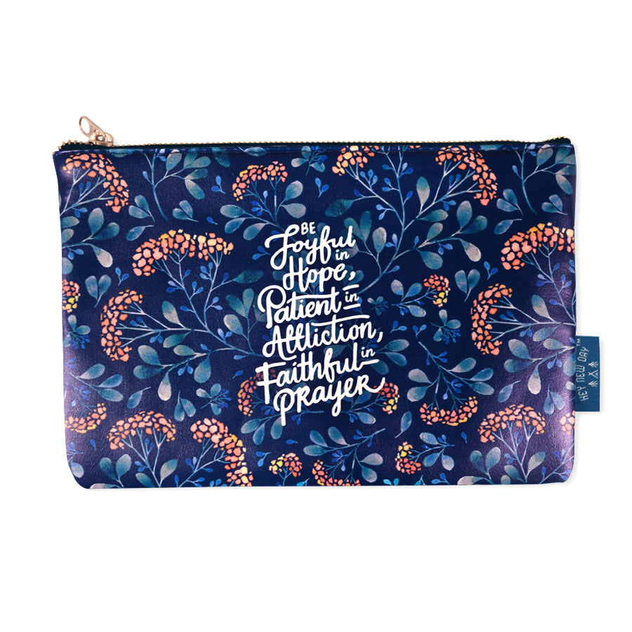 Multipurpose PU Leather pouch in blue painting with garden designs on it. Features bible verse ‘Be joyful in hope, patient in affliction, faithful in prayer' in white lettering and is great Christian gift idea. The pouch has inner lining, gold zip. Dimensions: 21cm (W) x 14cm (H)