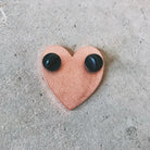 There are two pin backs for more secure pinning onto anything