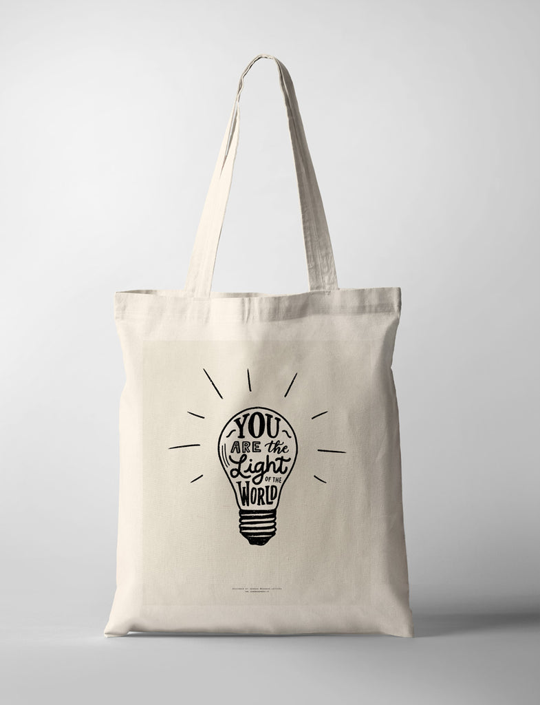 tote bag with you are the light of the world with a light bulb design