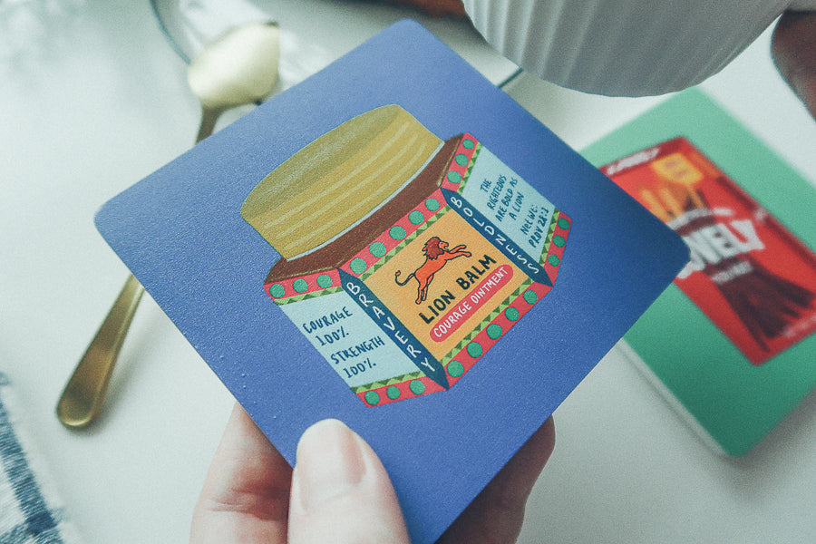 Lion Balm Christian wooden coaster lifestyle product view.