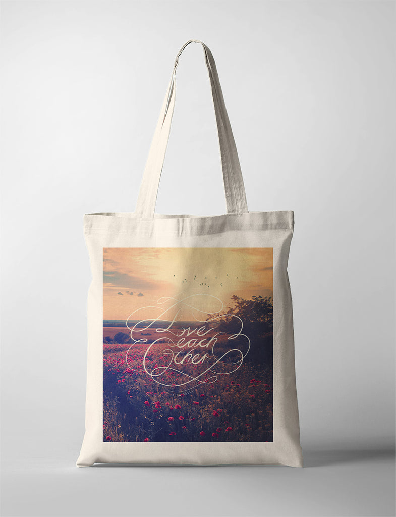 tote bag design that says "love each other"