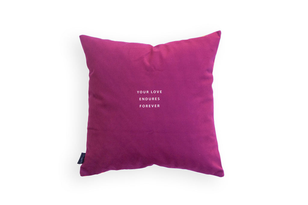 Maroon background with small white font 'your love endures forever' at the back of the pillow cover