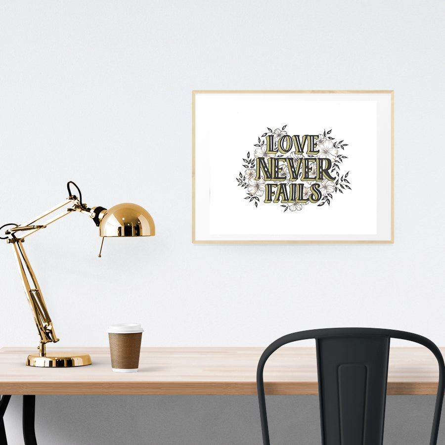 A3 beautiful calligraphy poster placed standing next to a smaller A4 sized calligraphy poster on a wooden table. Modern home interior design ideas.