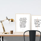 A3 calligraphy poster placed standing next to a smaller A4 sized calligraphy poster with on a wooden table. Inspiring home decor ideas.
