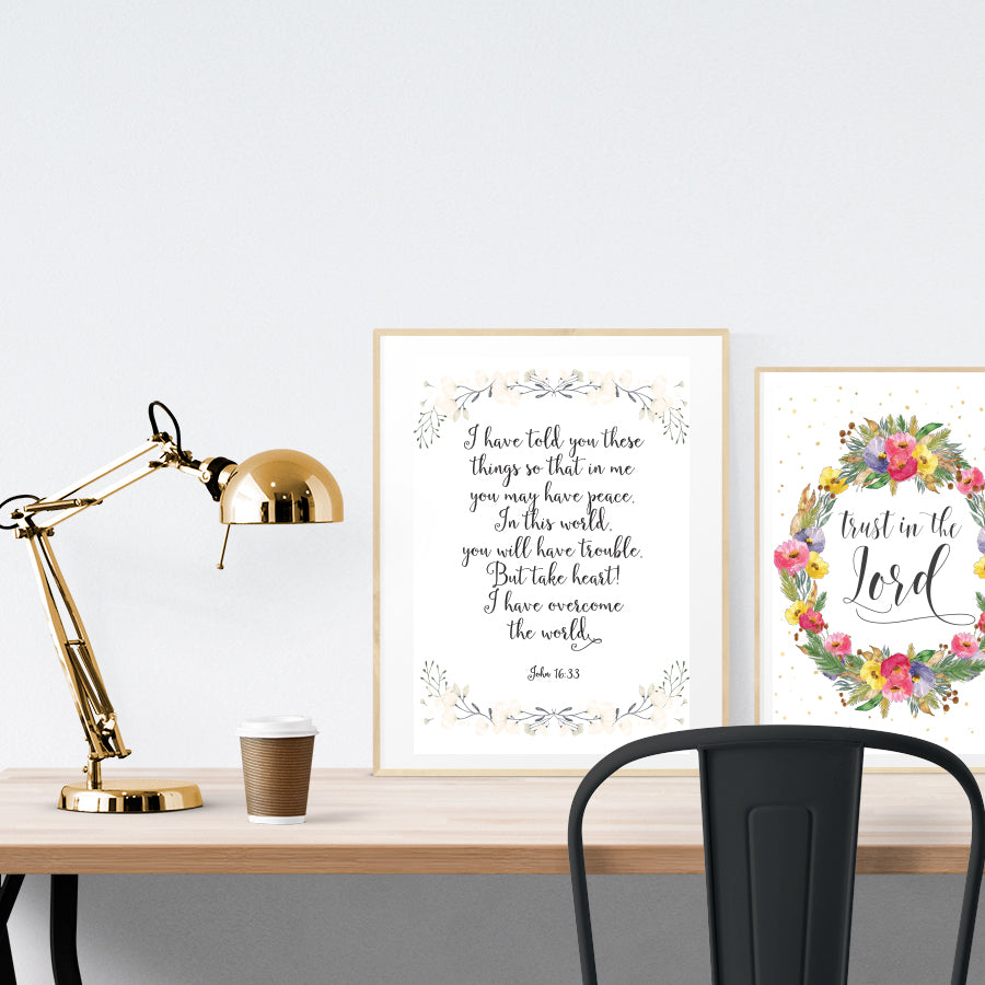 A3 beautiful calligraphy poster placed standing next to a smaller A4 sized calligraphy poster on a wooden table. Modern home interior design ideas.