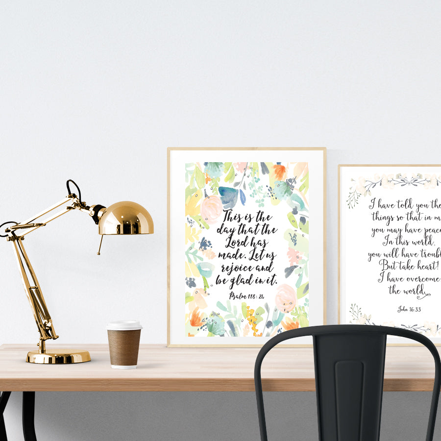 A3 beautiful calligraphy poster placed standing next to a smaller A4 sized calligraphy poster on a wooden table. Pretty home interior design ideas.