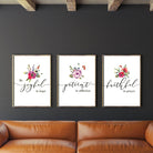 Three posters hung on a black wall.  Rustic modern home decor ideas.