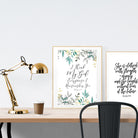 A3 beautiful calligraphy poster placed standing next to a smaller A4 sized calligraphy poster on a wooden table. Modern home interior design ideas.