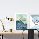 A3 calligraphy poster placed standing next to a smaller A4 sized calligraphy poster with on a wooden table. Inspiring home decor ideas.