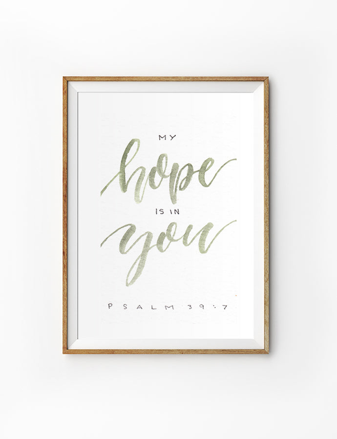 Poster featuring beautiful typography bible verses with colourful font designs ‘my hope is in you’ is hung on the wall in a gold photo frame’. 200GSM paper, available in A3,A4 size.