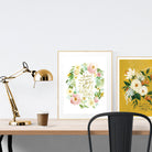 A3 beautiful calligraphy poster placed standing next to a smaller A4 sized calligraphy poster on a wooden table. Modern home interior design ideas. Rustic decor ideas