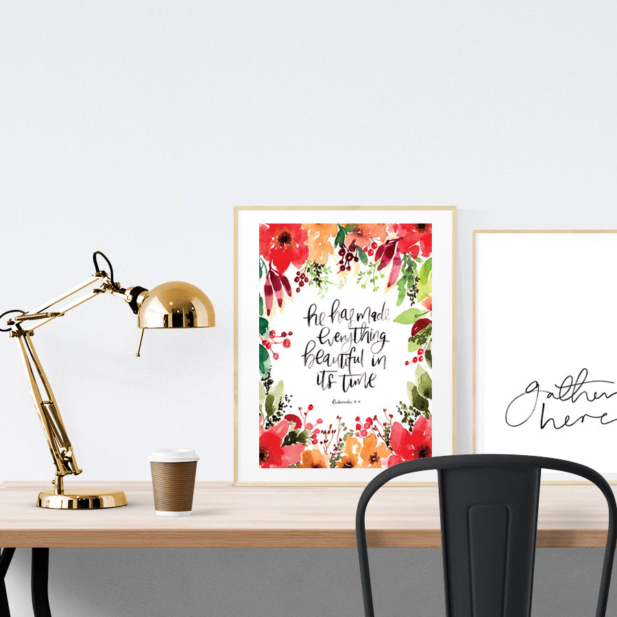 A3 beautiful calligraphy with flowers poster placed standing next to a smaller A4 sized calligraphy poster on a wooden table. Inspiring home decor ideas.