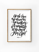 Poster featuring beautiful typography bible verses with water colour designs ‘He who began a good work in you will bring it to completion at the day of Jesus Christ’ is hung on the wall in a gold photo frame’. 200GSM paper, available in A3,A4 size.