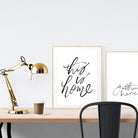 A3 beautiful calligraphy poster placed standing next to a smaller A4 sized calligraphy poster on a wooden table. Minimalistic home interior design ideas.
