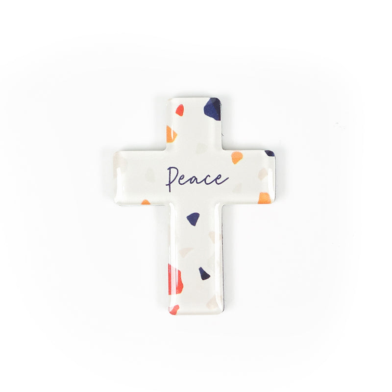 Cross acrylic magnet with colourful terrazzo design. And the encouraging message 'Peace' in blue.