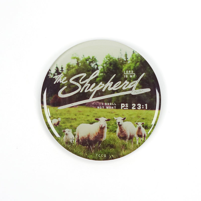 5.5 cm diameter circular Acrylic fridge magnet with bible verse “The Lord is my shepherd I shall not want” on sheep and grassland background.