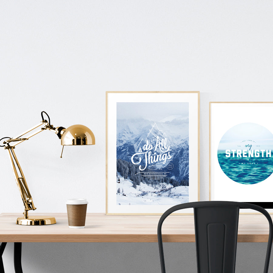 A3 beautiful calligraphy poster placed standing next to a smaller A4 sized calligraphy poster on a wooden table. Modern home interior design ideas.