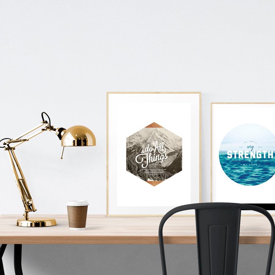 A3 beautiful calligraphy poster placed standing next to a smaller A4 sized sea poster on a wooden table. Modern home interior design ideas.
