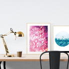 A3 beautiful calligraphy poster placed standing next to a smaller A4 sized calligraphy poster on a wooden table. Modern home interior design ideas.