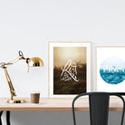 A3 beautiful calligraphy poster placed standing next to a smaller A4 sized calligraphy poster on a wooden table. Modern home interior design ideas.