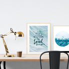 A3 beautiful calligraphy poster placed standing next to a smaller A4 sized calligraphy poster on a wooden table. Calm home interior design ideas.