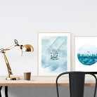 A3 beautiful calligraphy poster placed standing next to a smaller A4 sized calligraphy poster on a wooden table. Calm home interior design ideas.