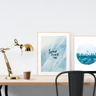 A3 beautiful calligraphy poster placed standing next to a smaller A4 sized calligraphy poster on a wooden table. Calm home interior design ideas.