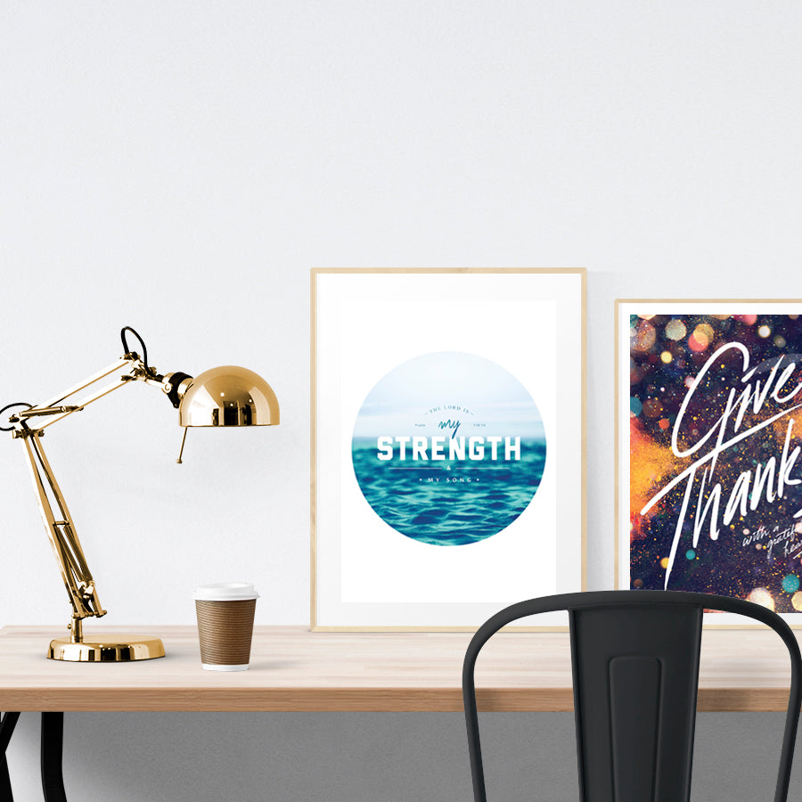 A3 beautiful calligraphy poster placed standing next to a smaller A4 sized calligraphy poster on a wooden table. Calm home interior design ideas.