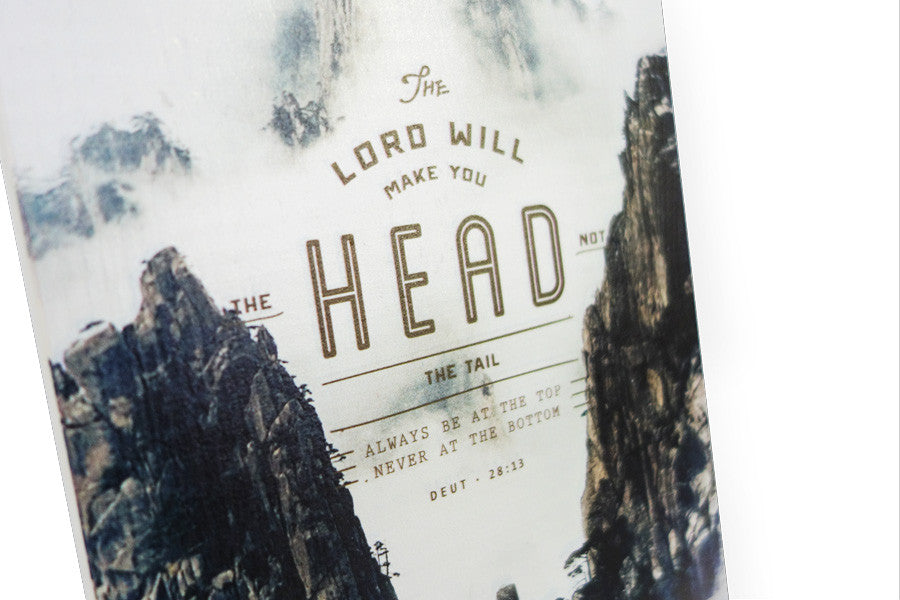 Close up of motivational bible verse ‘Head not the tail, top not bottom’ on mountain tops background with  black font details digitally printed on 16cmx20cm quality pine wood.