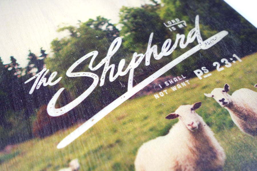 Close up of motivational bible verse ‘The Lord is my shepherd’ on sheep and grassland background with white font details digitally printed on 16cmx20cm quality pine wood.