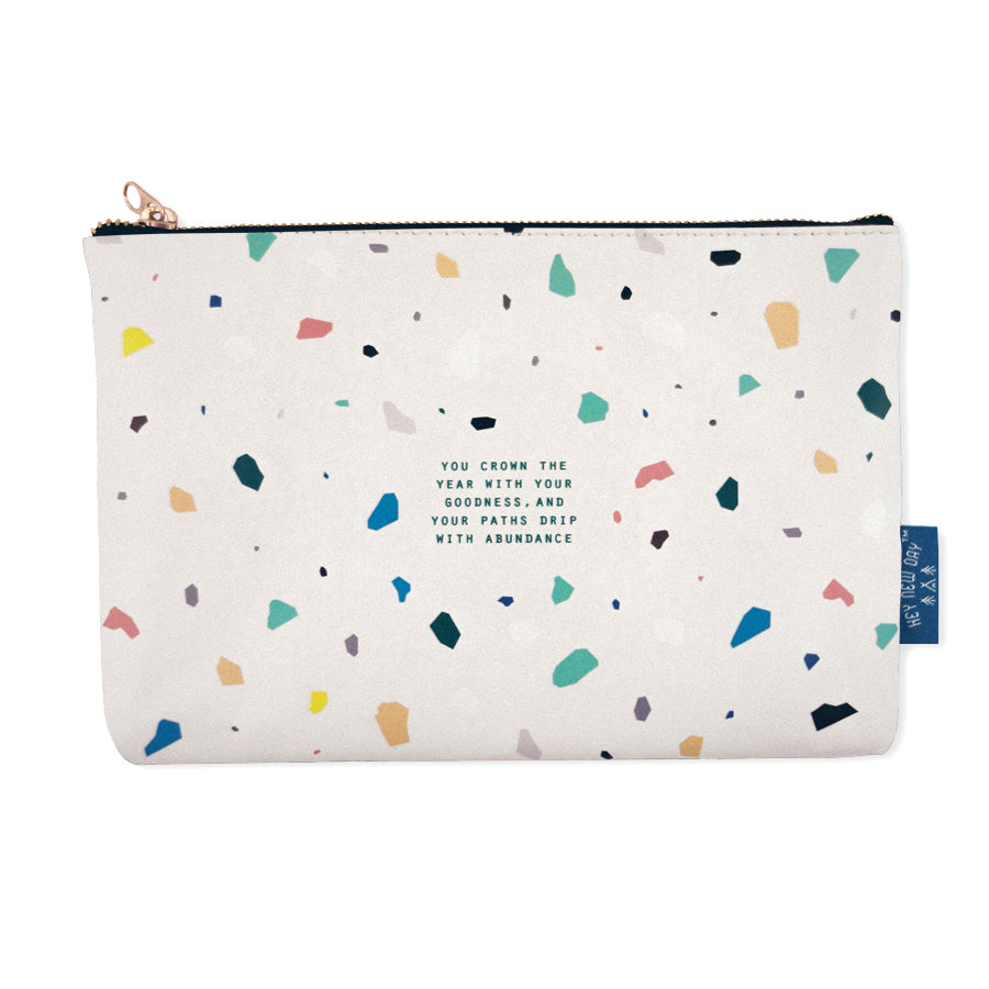 Multipurpose PU Leather pouch in off white with terrazzo designs on it. Features bible verse ‘ you crown the year with your goodness, and your paths drip with abundance' in blue lettering and is great Christian gift idea. The pouch has inner lining, gold zip. Dimensions: 21cm (W) x 14cm (H)